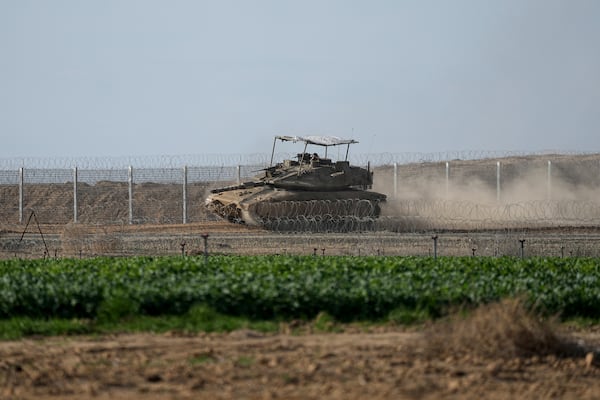 An Israeli army tank moves along the border with the Gaza Strip in southern Israel on Sunday, Jan. 19, 2025. (AP Photo/Tsafrir Abayov)