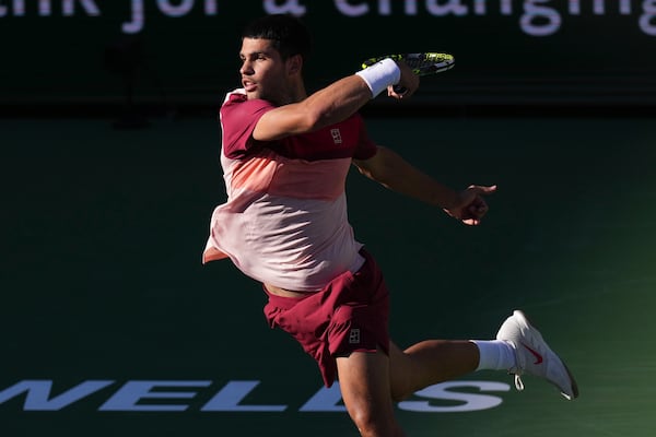 Carlos Alcaraz, of Spain, returns to Jack Draper, of Great Britain, during their semifinals match at the BNP Paribas Open tennis tournament Saturday, March 15, 2025, in Indian Wells, Calif. (AP Photo/Mark J. Terrill)