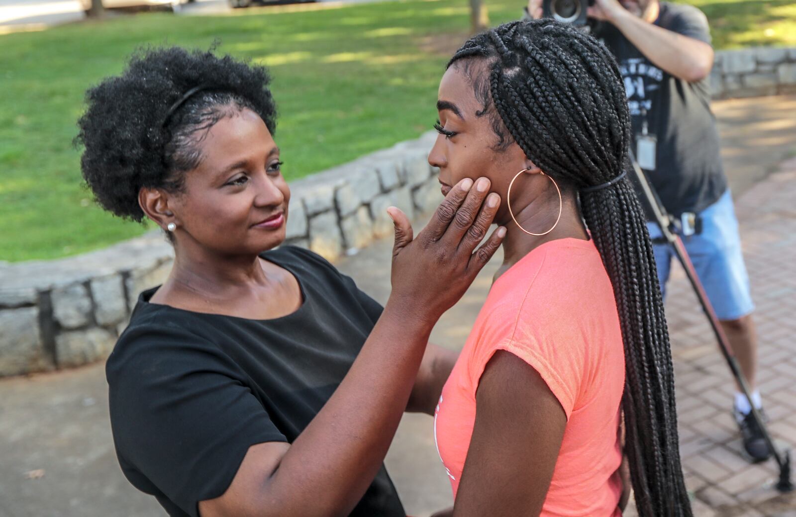 Aug 23, 2019 : 19-year old Clark Atlanta University student, Kia Thomas (right) gets a hug from her mother Michelle Thomas (left) after she spoke to the media at Cleopas R. Johnson Park Friday morning, August 23, 2019 about the shooting on campus where a bullet grazed her. Hours before the start of a new school year, four students were injured in a shooting at a block party Tuesday night outside the Atlanta University Center library. Two Spelman College students and two Clark Atlanta University students, all of whom are women, were taken to a hospital with injuries ranging from graze wounds to gunshot wounds, according to Atlanta police. They were hit around 10:30 p.m., when someone opened fire into a crowd of about 200 people in front of the Robert W. Woodruff Library on James P. Brawley Drive. JOHN SPINK/JSPINK@AJC.COM