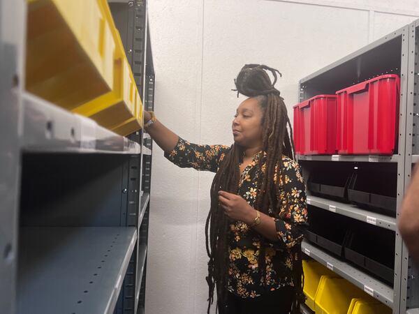 L'Angela Lee looks at her products stored at the Logistics Launchpad at the Russell Innovation Center for Entrepreneurs.