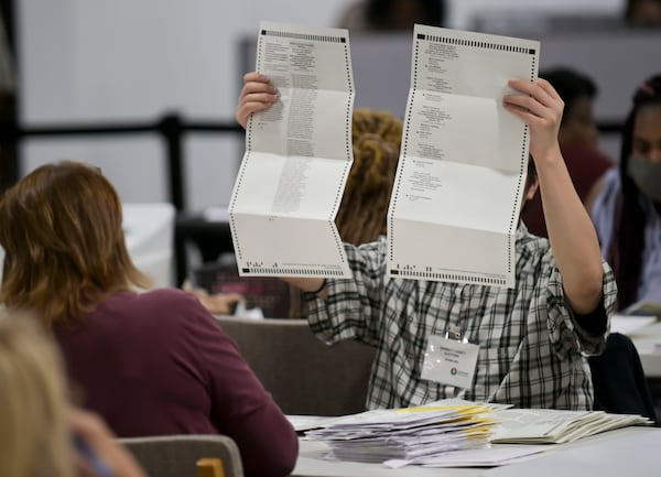 Workers sort absentee ballots at the Gwinnett Voter Registrations and Elections Building in November 2022. (Daniel Varnado/For the AJC)