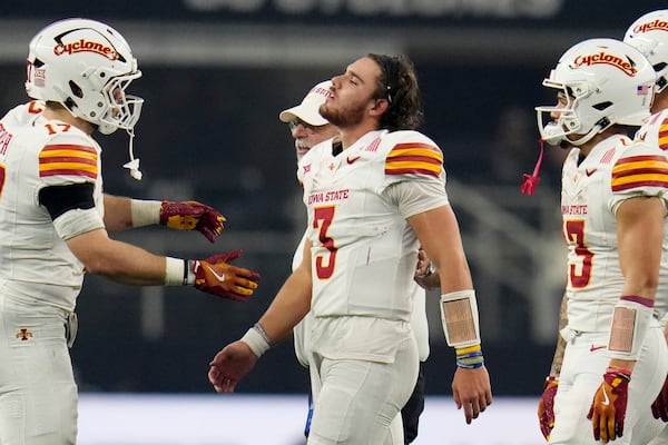 Iowa State quarterback Rocco Becht (3) is assisted off the field after taking a hit in the second half of the Big 12 Conference championship NCAA college football game against Arizona State, in Arlington, Texas, Saturday Dec. 7, 2024. (AP Photo/Julio Cortez)