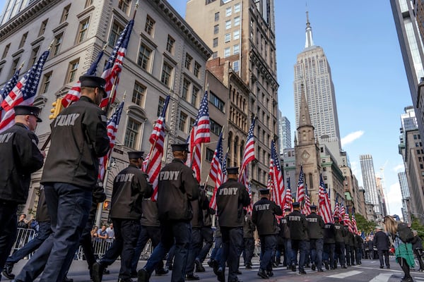 Member of the New York City Fire Department (FDNY) carry American flags during the annual Veterans Day Parade, Monday, Nov. 11, 2024, in New York. (AP Photo/Adam Gray)