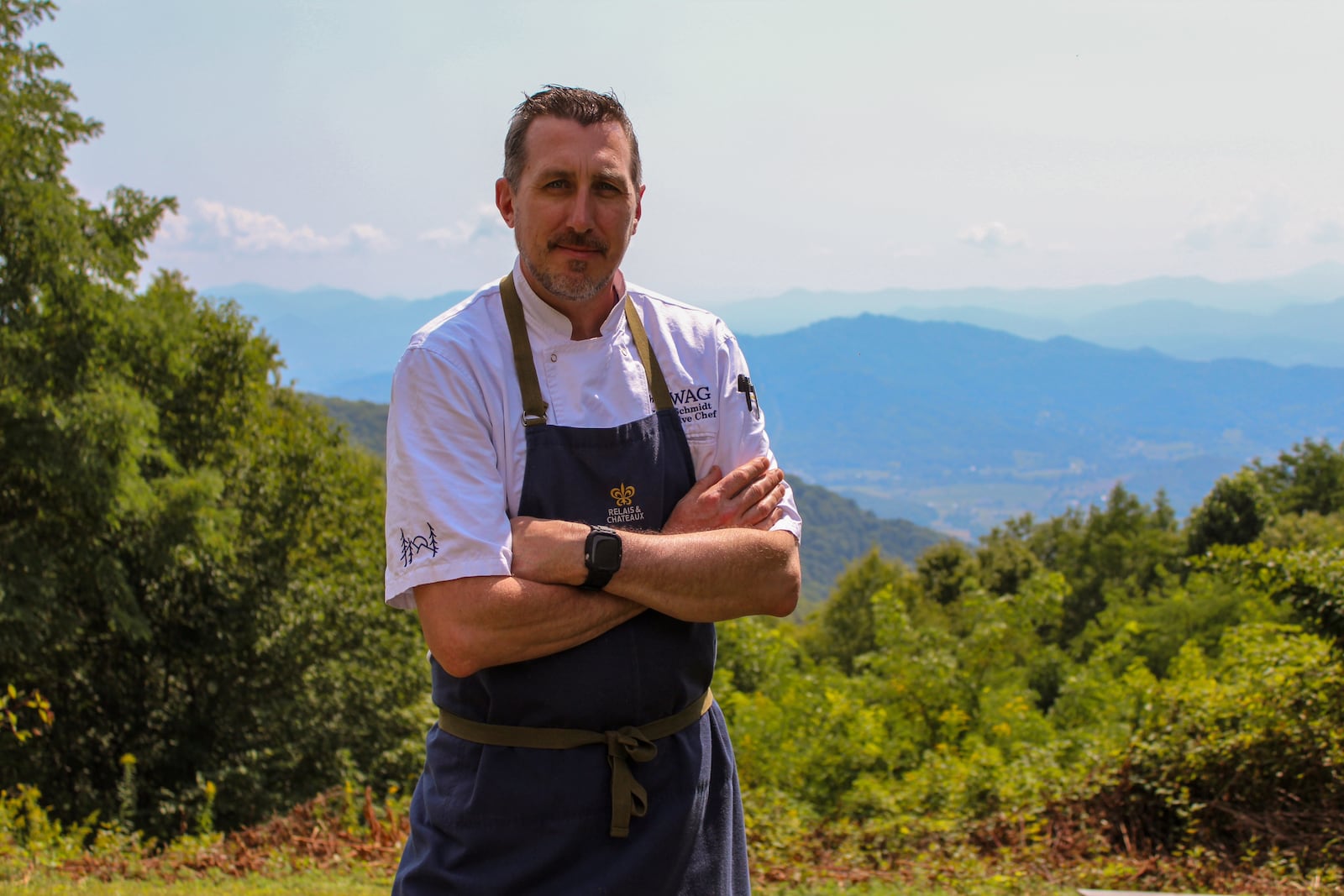 Chef Jake Schmidt stands on the Swag's property in the Great Smoky Mountains. Schmidt reveres the quality of produce grown in Western North Carolina's soil and bases his menu around local ingredients. (Courtesy of Becky Seymour)