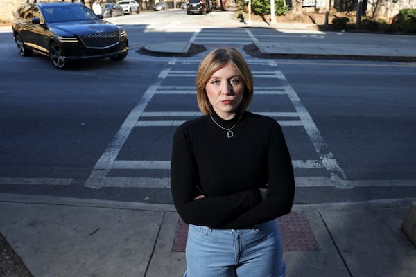 Veronica Watts poses for a portrait near the crosswalk of North Avenue in Midtown, Friday, Jan. 24, 2025, in Atlanta. In February 2024, Watts was hit by a driver at this crosswalk and was thrown 38 feet. She is trying to have Georgia traffic laws changed after she was hit. (Jason Getz / AJC)