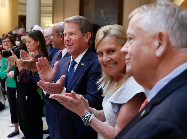 Gov. Brian Kemp, with his wife, Marty, applauds House Speaker Ralston before he signed HB 1013, which aims to increase access to mental health coverage in Georgia on Sine Die, the last day of the General Assembly at the Georgia State Capitol in Atlanta on Monday, April 4, 2022.   (Bob Andres / robert.andres@ajc.com)