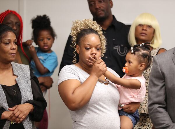 061520 Atlanta: Tomika Miller, the wife of Rayshard Brooks, holds their daughter Memory, 2, gently kissing her hand during the family press conference on Monday, June 15, 2020, in Atlanta. Brooks was killed by an APD officer Friday.  Curtis Compton ccompton@ajc.com