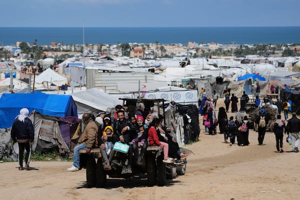 Displaced Palestinians, who flee from Rafah amidst ongoing Israeli military operations following Israel's renewed offensive in the Gaza Strip, arrive in Khan Younis, Gaza, on Sunday, March 23, 2025. (AP Photo/Abdel Kareem Hana)