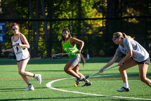 Natajha Graham (middle) plays defense during the Spelman College lacrosse game on Sunday, October 23, 2022, at Hammond Park in Sandy Springs, Georgia. Several girls on the Spelman team said that joining the lacrosse team was the first time they felt a part of something on campus. CHRISTINA MATACOTTA FOR THE ATLANTA JOURNAL-CONSTITUTION.