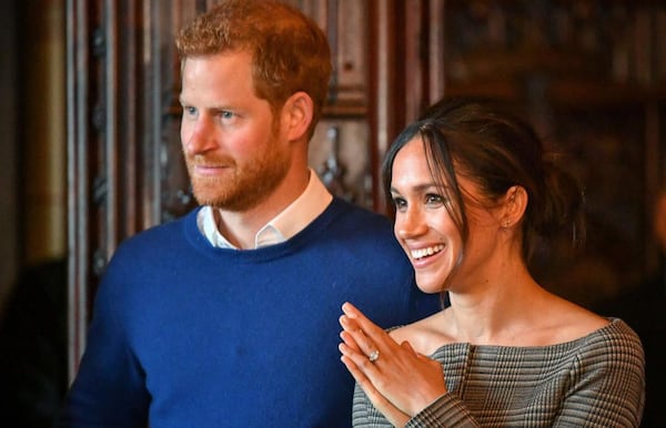 Prince Harry and Meghan Markle watch a performance by a Welsh choir in the banqueting hall during a visit to Cardiff Castle on January 18, 2018 in Cardiff, Wales.