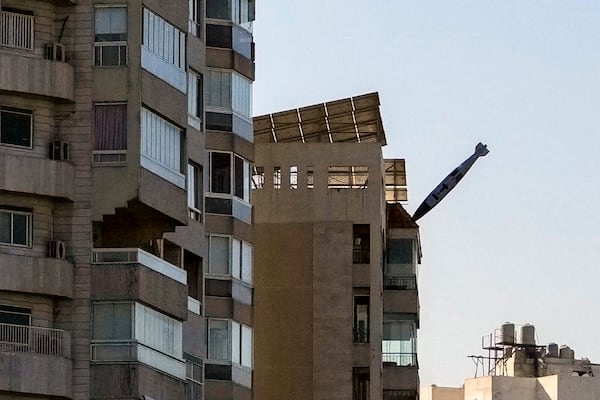 A bomb dropped from an Israeli jet prepares to hit a building in Tayouneh, Beirut, Lebanon, Friday, Nov. 15, 2024. (AP Photo/Hassan Ammar)