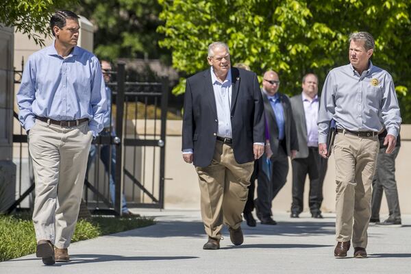 Georgia Gov. Brian Kemp (right) is joined by Georgia Lt. Gov. Geoff Duncan (left) and Georgia Speaker of the House David Ralston (center) before the start of a press conference at Liberty Plaza, across the street from the state Capitol building in Atlanta on Monday, April 20, 2020. During the presser, Gov. Kemp revealed that he planned to allow some small business owners to open back up by the end of the week. (ALYSSA POINTER / Alyssa.Pointer@AJC.com)