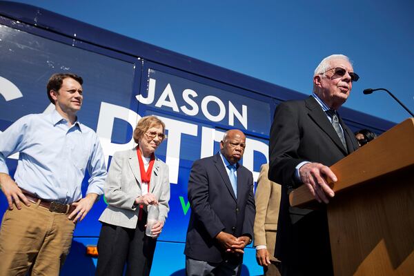 Former President Jimmy Carter, right, introduces his grandson, Georgia Democratic gubernatorial candidate Jason Carter, rear left, at a campaign stop with former first lady Rosalynn Carter and Rep. John Lewis, D-Ga., center left and right, Monday, Oct. 27, 2014, in Columbus, Ga. (AP Photo/David Goldman)