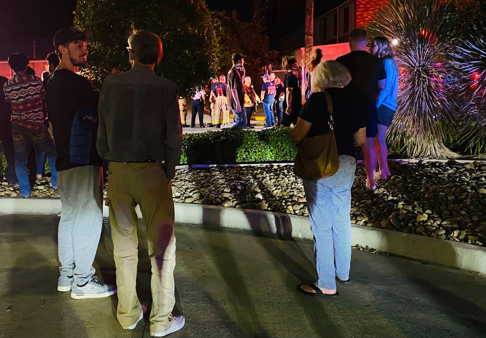 People gather near the site of a helicopter crash Sunday, Oct. 20, 2024, in Houston. (Raquel Natalicchio/Houston Chronicle via AP)