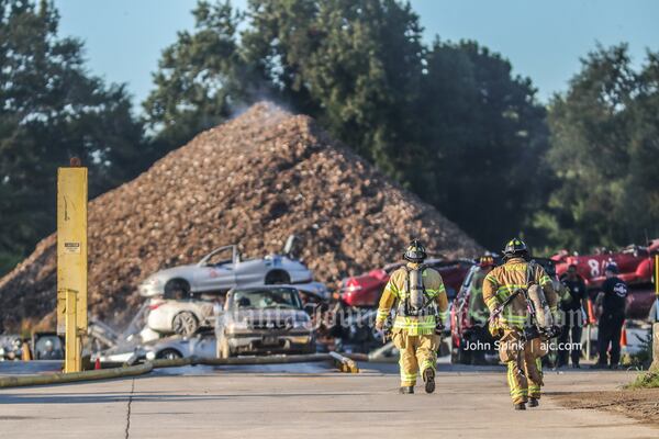 Firefighters put out hotspots at the Encore Recycling plant off Chapman Road.