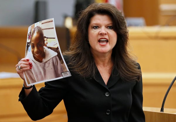 Assistant district attorney Lisa Jones holds a photo of Emani Moss as she delivers final arguments for the prosecution during the Tiffany Moss murder trial on April 29, 2019.