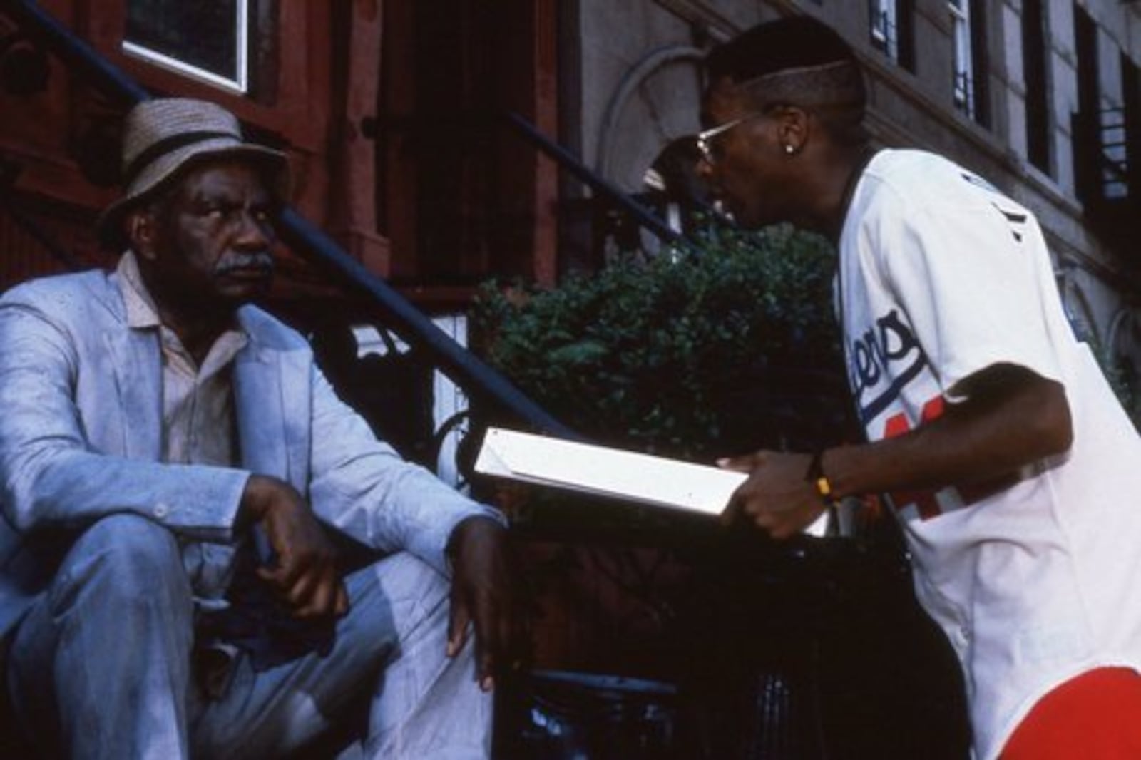 OSSIE DAVIS and Spike Lee are shown around the neighborhood.