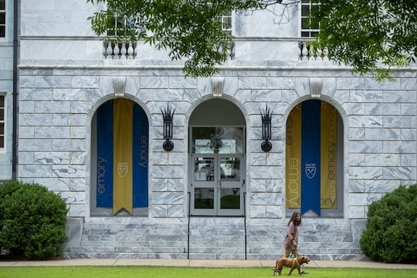 A person walks their dog on the Emory University Campus in Atlanta, Tuesday June 29, 2021. (Alyssa Pointer / Alyssa.Pointer@ajc.com)

