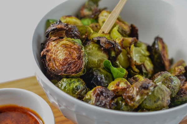 Roasted Brussels sprouts are not only a side dish for supper but also a healthy afternoon snack. (Virginia Willis for The Atlanta Journal-Constitution)