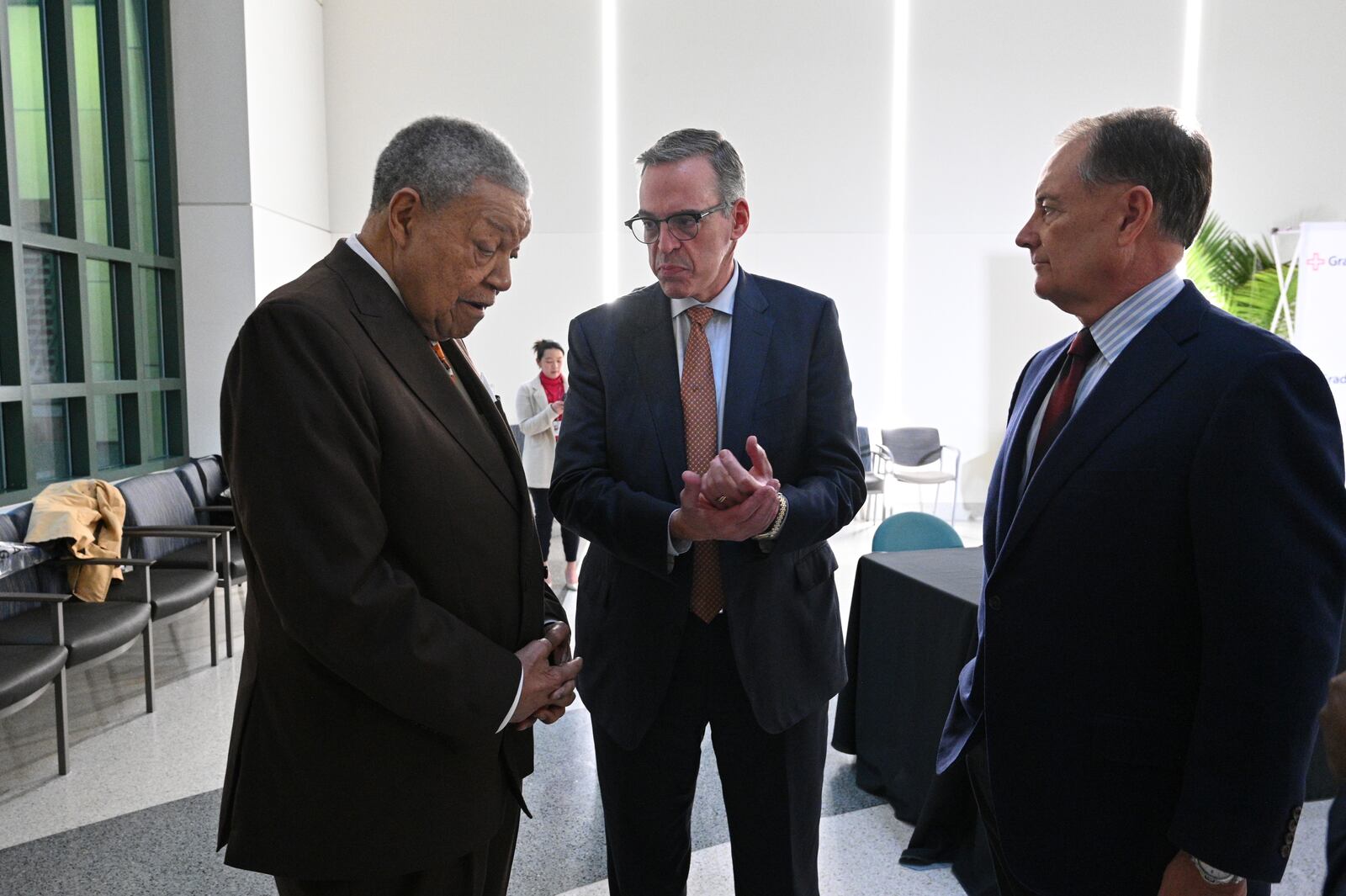 Robb Pitts (left), Chairman of the Fulton County Board of Commissioners, talks with John Haupert (center), president and CEO of Grady Health System, before a press conference to announce and sign a new deal to subsidize the hospital for indigent medical care at Grady Memorial Hospital, Tuesday, December 9, 2024, in Atlanta. (Hyosub Shin / Hyosub.Shin@ajc.com)