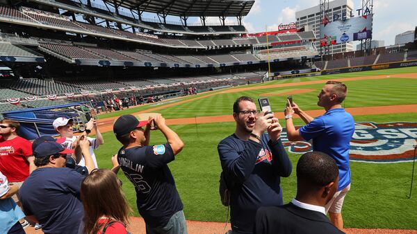 April 14, 2017, Atlanta: Braves fans snap photos from the field before the home opener in their new stadium at SunTrust Park on Friday, April 14, 2017, in Atlanta.  Curtis Compton/ccompton@ajc.com