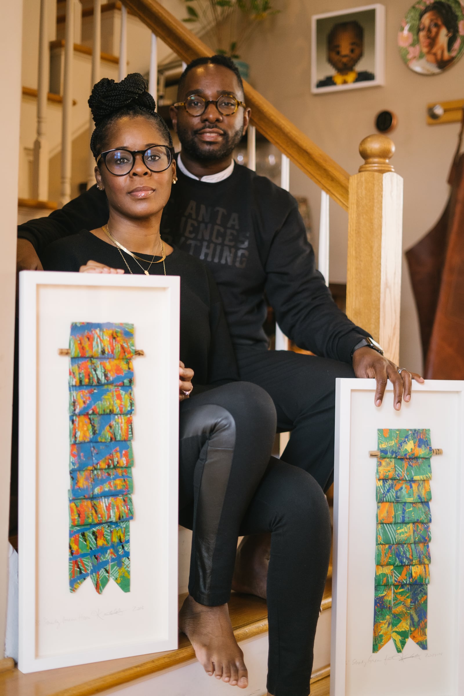 Esohe and George Galbreath, holding works by Kevin Cole, have an art collection numbering 200 pieces. Courtesy of Melissa Alexander