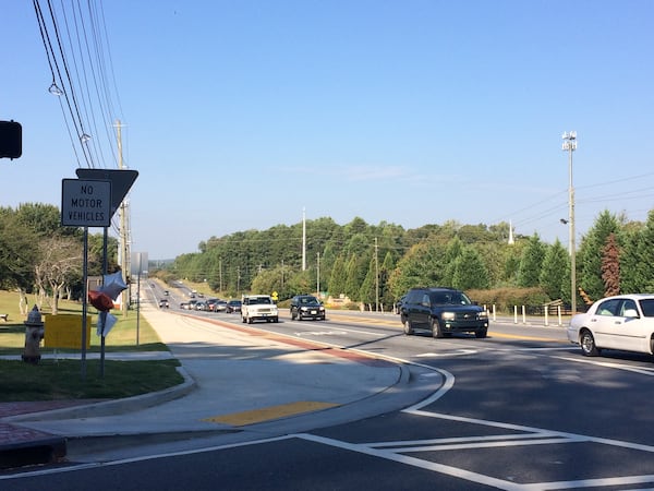 Sidewalk at the intersection of Dallas Highway and John Ward Road. (BECCA GODWIN / BECCA.GODWIN@AJC.COM)