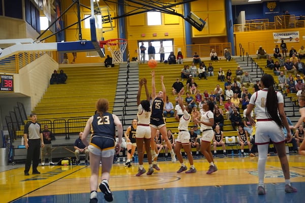 Three Creekside defenders close in as Marist's Kate Harpring shoots near the basket. Photo courtesy of Meredyth Gaynes