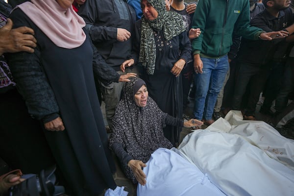 A woman mourns over the bodies of victims from an Israeli airstrike outside a hospital in Deir al-Balah, Gaza, Sunday Nov. 17, 2024. Palestinian medical officials reported Sunday that Israeli strikes overnight killed 12 people in Central Gaza. One child and five women were counted among them.(AP Photo/Abdel Kareem Hana)