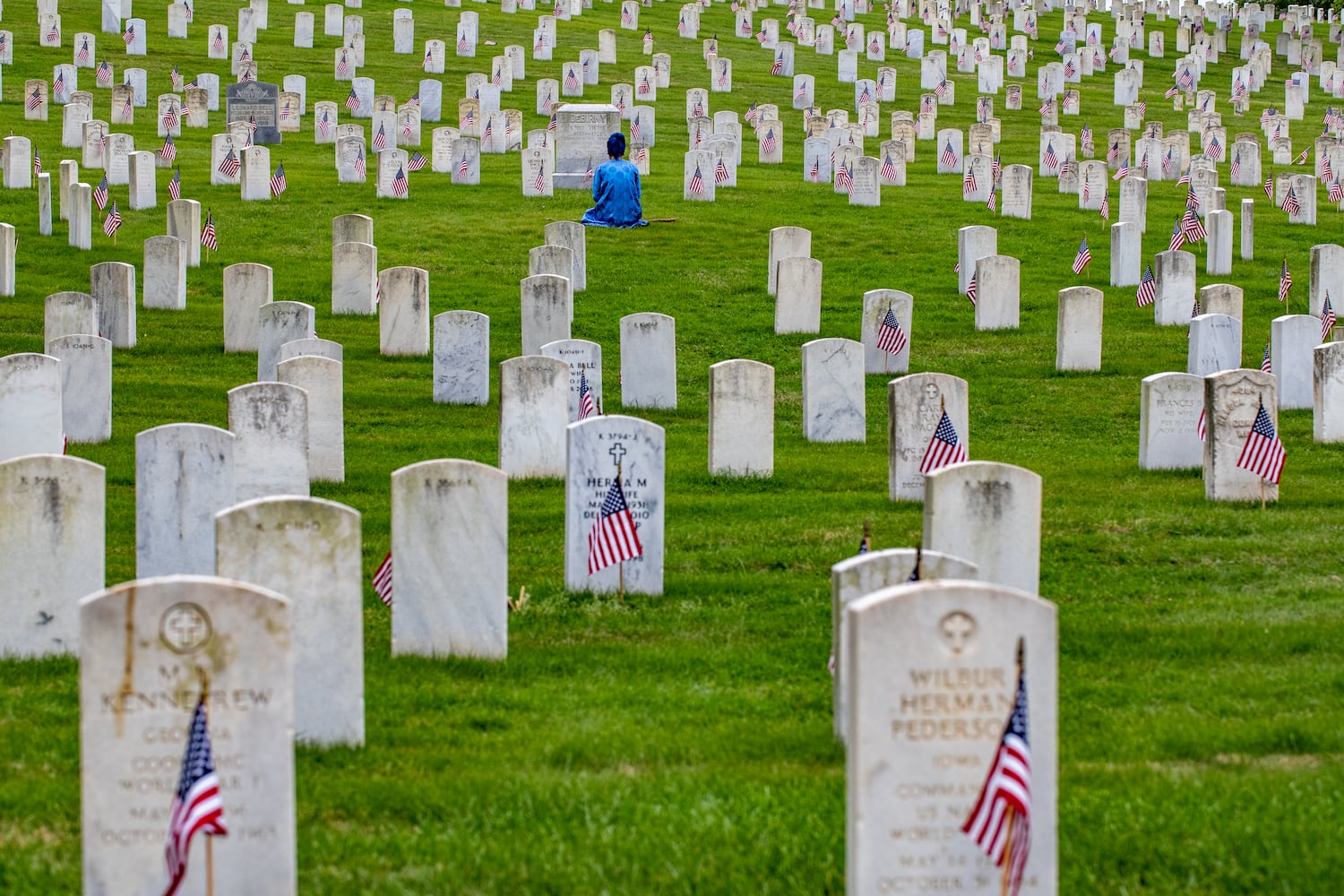 Alexandria Quillen comes from a military family and feels spiritually led to pay respect and lay flowers at the graves of soldiers in the Marietta National Cemetery on Monday, May 29, 2003. The National Memorial Day Association of Georgia holds the 77th annual Memorial Day Observance at the national cemetery.  (Jenni Girtman for The Atlanta Journal-Constitution)