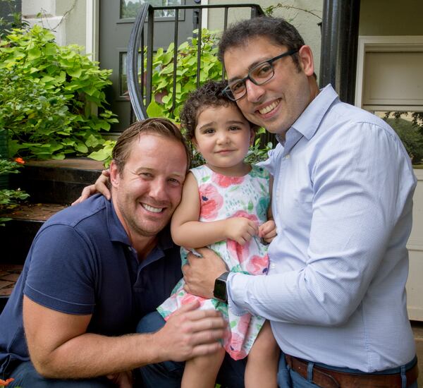 Derek Mize, left, and Jonathan Gregg, right, have won a legal battle with the U.S. State Department for their daughter, 2-year-old Simone Mize-Gregg, to be declared a U.S. citizen. (Jenni Girtman for The Atlanta Journal-Constitution)