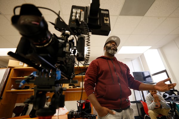 Media Arts Teacher Michael Morris speaks to his students during a media class at Utopian Academy on Tuesday, Dec. 13, 2022. Utopian Academy is partnering with Trilith Studios, the home of Marvel and D.C. blockbusters, in teaching young children about the world of film and TV.
 Miguel Martinez / miguel.martinezjimenez@ajc.com