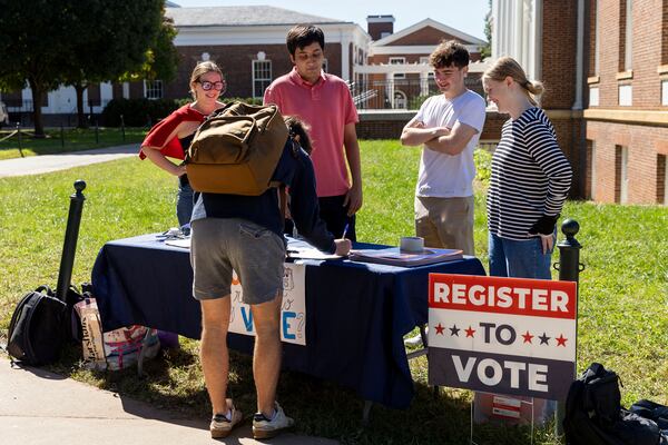 Eleanor Clemons, Kushaan Soodan, James Galvin and Cate Love register students to vote at the University of Virginia in Charlottesville, Va., Friday, Oct. 11, 2024. (AP Photo/Ryan M. Kelly)