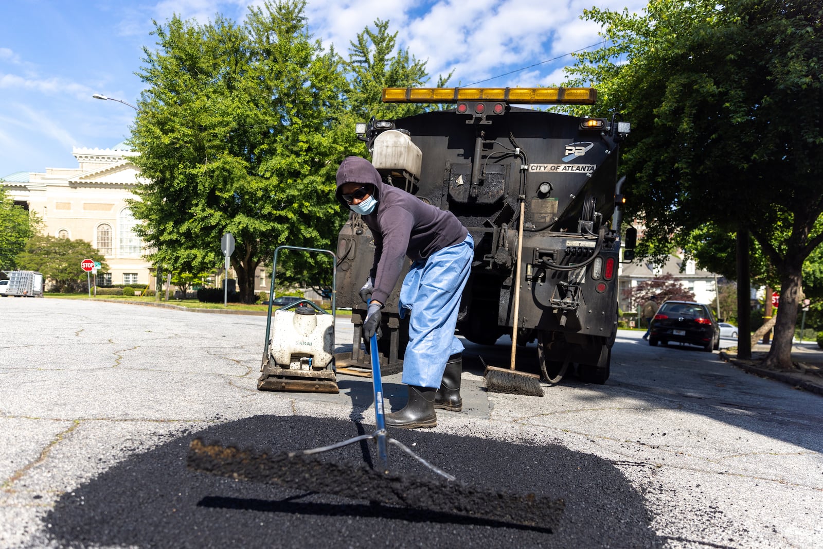 Atlanta Department of Transportation construction maintenance worker Rico Gooden fixes a pothole in Atlanta on Tuesday, April 25, 2023. With the city's population continuing to grow and major events like the 2026 FIFA World Cup coming, city officials question what they see as a lack of funding to sustain basic infrastructure. (Arvin Temkar / arvin.temkar@ajc.com)