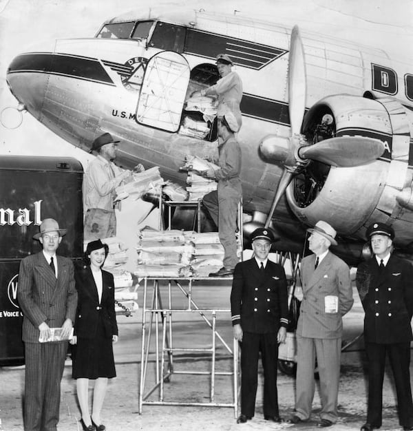 Delta Air employees load up the first air express editions of The Atlanta Journal onto an awaiting plane on May 3, 1945. It was described as the primary step in bringing "today's news today" to readers in Augusta and Savannah. (AJC file)