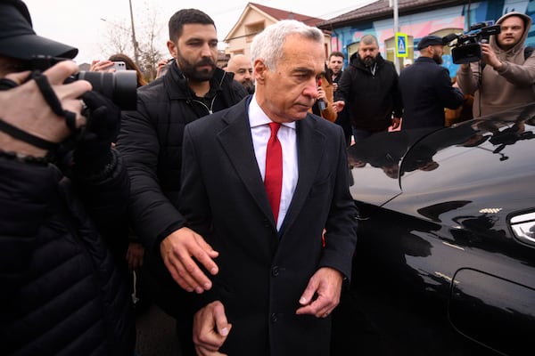 Calin Georgescu, an independent candidate for president who came first after the first round of presidential elections, leaves after casting his vote in the country's parliamentary elections, in Mogosoaia, Romania, Sunday, Dec. 1, 2024. (AP Photo/Alexandru Dobre)