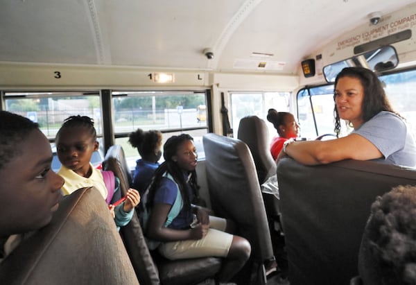 Atlanta Public Schools Superintendent Meria Carstarphen greets children on a school bus on Aug. 12, 2019, the first day of the school year. AJC file photo. BOB ANDRES / ROBERT.ANDRES@AJC.COM