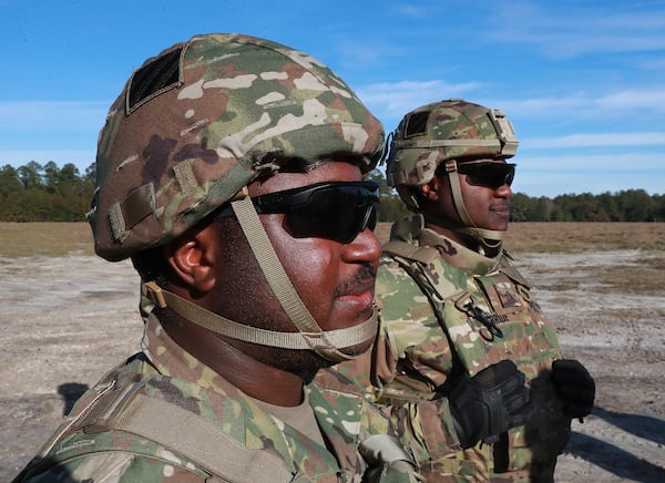 Fraternal twins Ryan (left) and Matthew McBride during training exercises in December at Fort Stewart ahead of a nine-month deployment to Afghanistan to train that nation’s security forces. Curtis Compton/ccompton@ajc.com