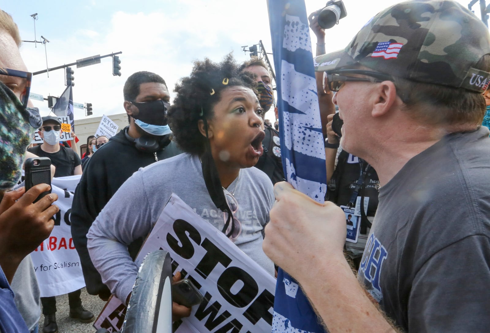 Counterprotesters face off with protesters as several far-right groups, including militias and white supremacists, rally Saturday, Aug. 15, 2020, in the town of Stone Mountain, and a broad coalition of leftist anti-racist groups organized a counter-demonstration. Thereafter local authorities closed Stone Mountain Park. (Jenni Girtman for The Atlanta Journal-Constitution)