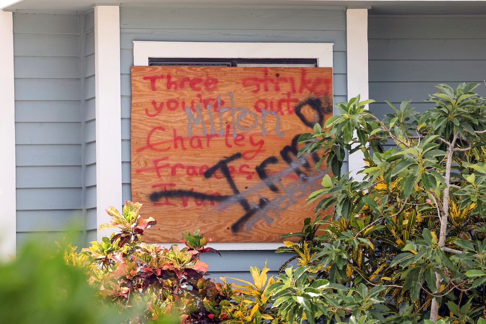 A sign on a home lists hurricane names in preparation for Hurricane Milton on Tuesday, Oct. 8, 2024, in New Port Richey, Fla. (AP Photo/Mike Carlson)