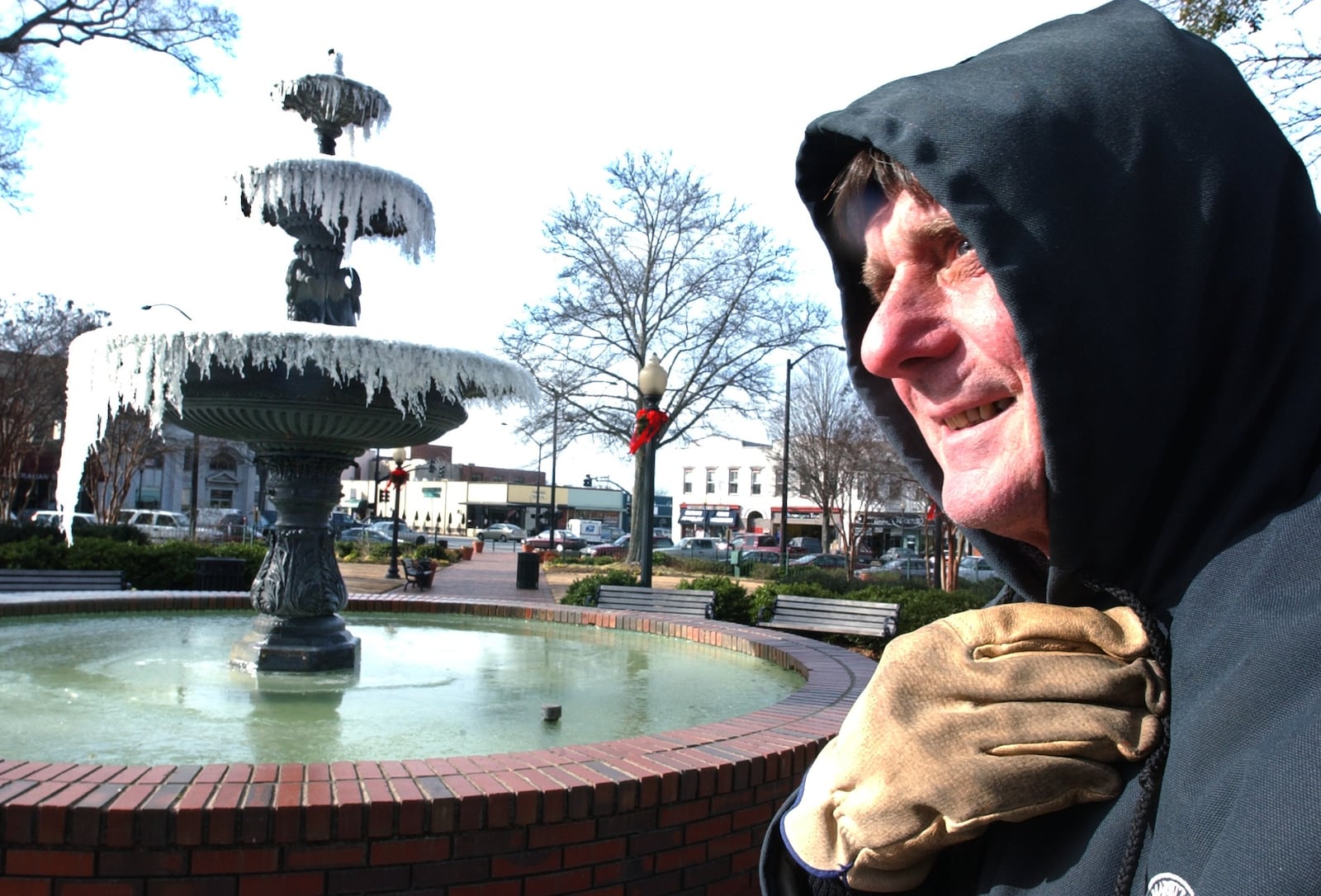 Jan. 7, 2004: City of Marietta employee Bob Keith tries to stay warm while cleaning Glover Park on the Marietta Square. The fountain sits frozen as the morning temperature in Marietta hovered around 19 degrees.