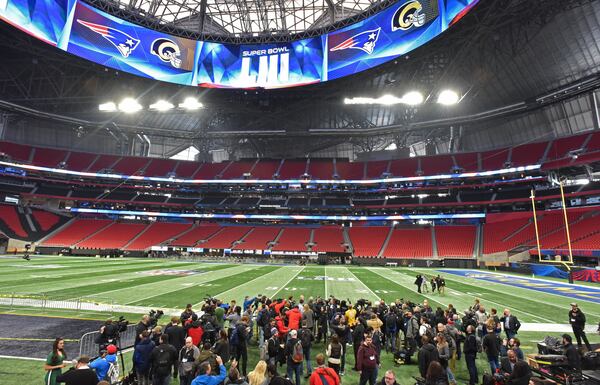 Members of the press film as stadium crew works inside Mercedes-Benz Stadium getting it ready for the Super Bowl LIII between New England Patriots and Los Angeles Rams on Tuesday, Jan. 29, 2019. (HYOSUB SHIN / HSHIN@AJC.COM)