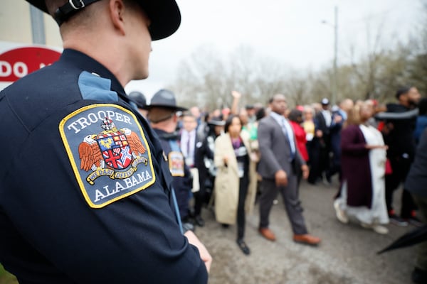 Alabama State Troopers monitor the crowd crossing Edmund Pettus Bridge during the 60th anniversary of Bloody Sunday on March 9, 2025, in Selma, Alabama. (Miguel Martinez/ AJC)