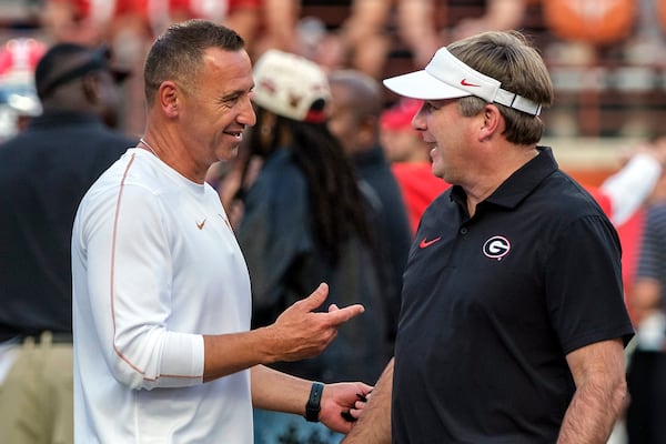 Texas coach Steve Sarkisian, left, and Georgia coach Kirby Smart talk during the pregame of an NCAA college football game in Austin, Texas, Saturday, Oct. 19, 2024. (AP Photo/Rodolfo Gonzalez)