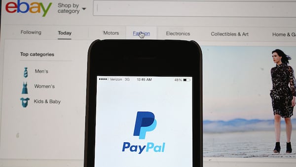 In this photo illustration, an eBay website is seen on a computer screen and the PayPal website is seen on an iphone on September 30, 2014 in Miami, Florida. (Photo by Joe Raedle/Getty Images)