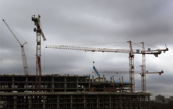 Dunwoody - Rain clouds build over the construction site of State Farm’s second tower in Dunwoody, located near a MARTA station. Eventually, three towers will form a campus for more than 8,000 workers, housing the southeastern operations for the insurance company. BOB ANDRES /BANDRES@AJC.COM