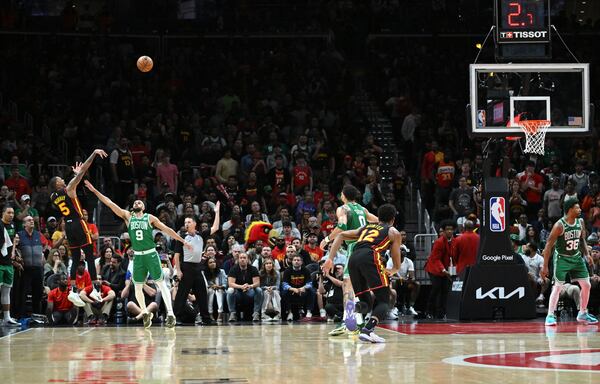 Atlanta Hawks' guard Dejounte Murray (5) shoots a 3-point basket over Boston Celtics' guard Derrick White (9) during the second half. (Hyosub Shin / Hyosub.Shin@ajc.com)