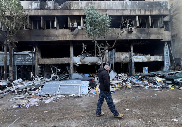 A Lebanese policeman walks in front of destroyed shops that were hit Sunday evening by an Israeli airstrike in central Beirut, Lebanon, Monday, Nov. 18, 2024. (AP Photo/Hussein Malla)