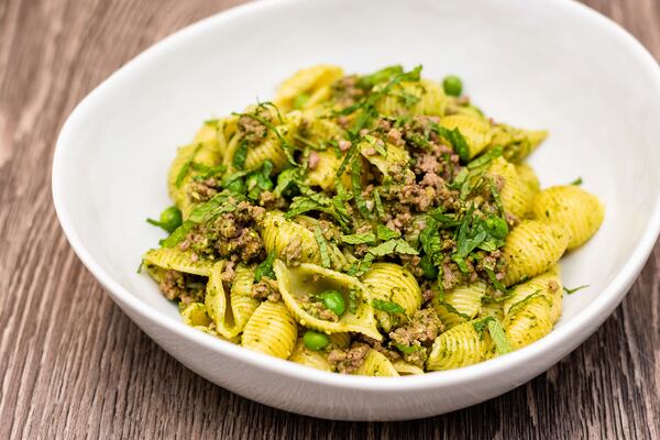 Pasta shells with lamb, pesto and peas.