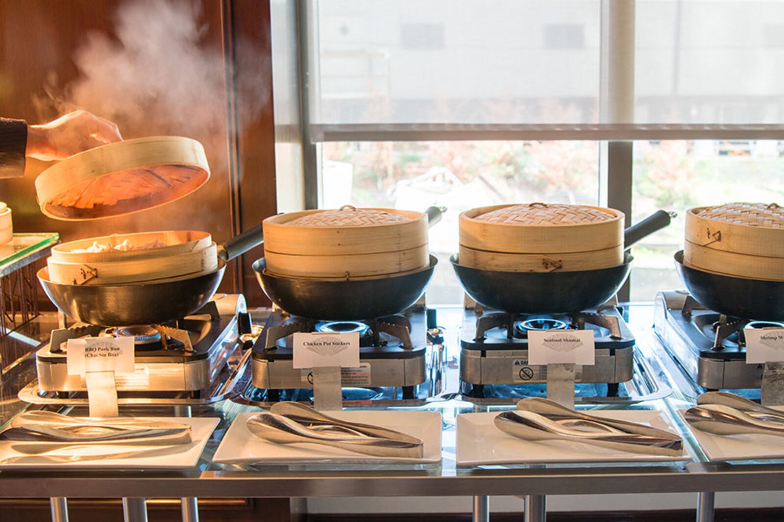 Traditional bamboo steamer baskets on the buffet at the Mandarin Oriental's weekend dim sum brunch. CONTRIBUTED BY HENRI HOLLIS